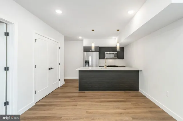 a view of kitchen with wooden floor