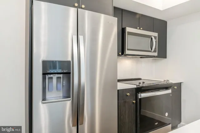 a kitchen with a refrigerator and a microwave