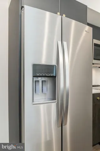 a metallic refrigerator freezer sitting in a kitchen