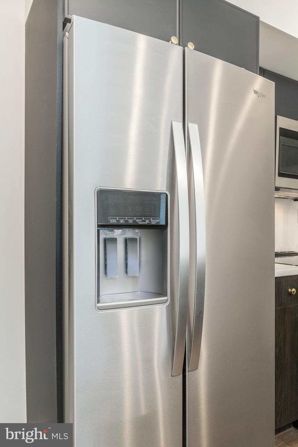 1102 Germantown Avenue, Unit 302 Philadelphia, PA 19123 - Photo 9 of 30 a metallic refrigerator freezer sitting in a kitchen