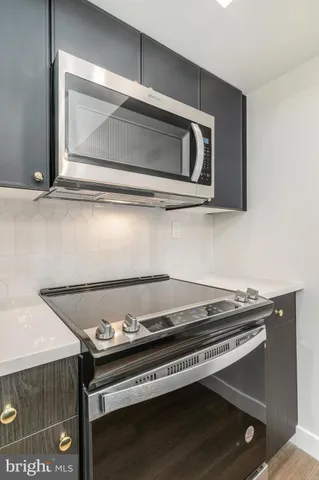 a stove top oven sitting inside of a kitchen