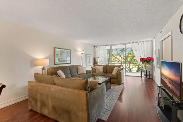 a living room with furniture potted plant and a window