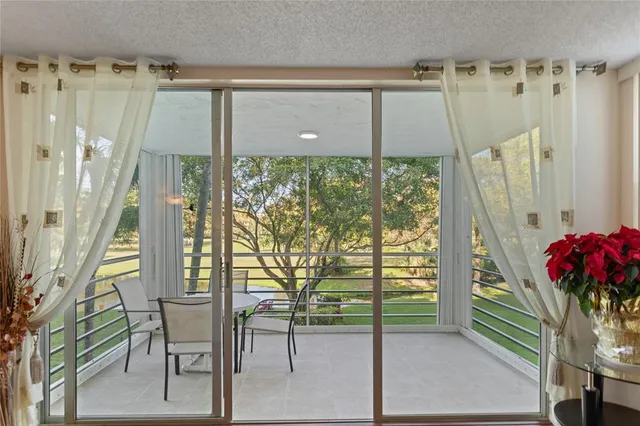a porch with a table and chairs