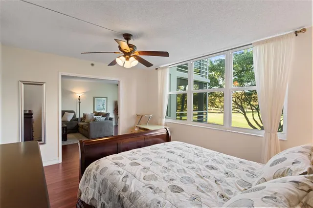 a bedroom with a bed and a large window