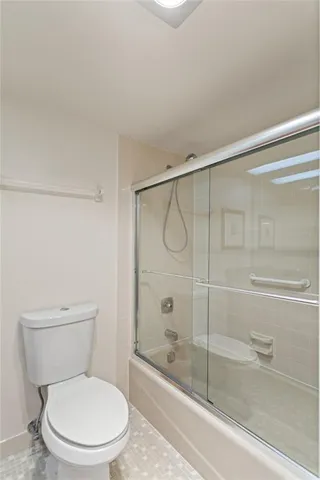 a bathroom with a toilet and a shower