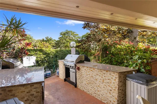 a view of a backyard door and tree