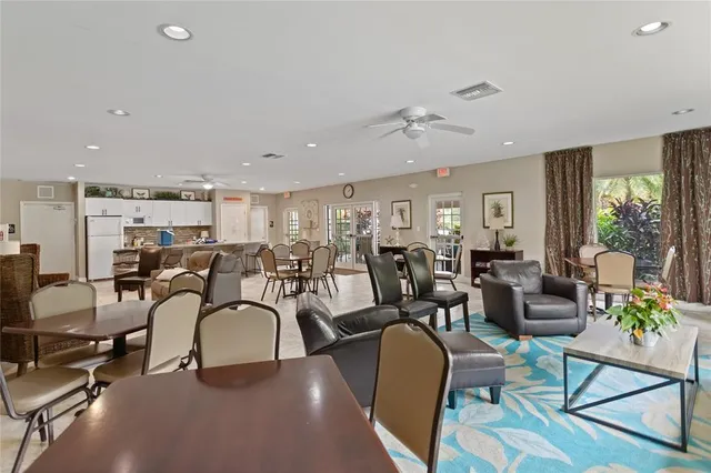 a living room with lots of chairs and a chandelier