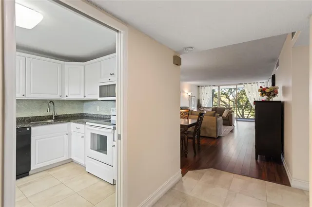 a kitchen with a refrigerator and a sink