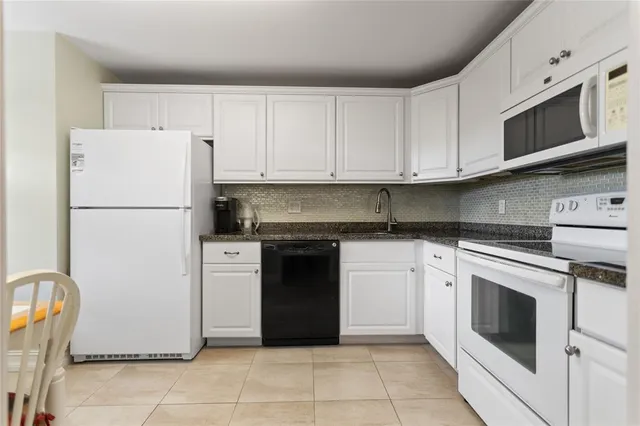 a kitchen with a stove top oven sink and cabinets
