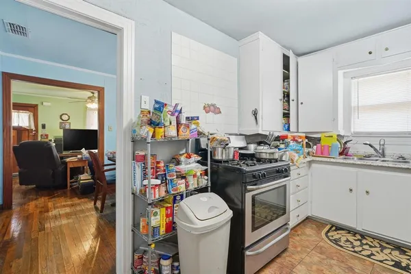 a kitchen with a sink stove and cabinets