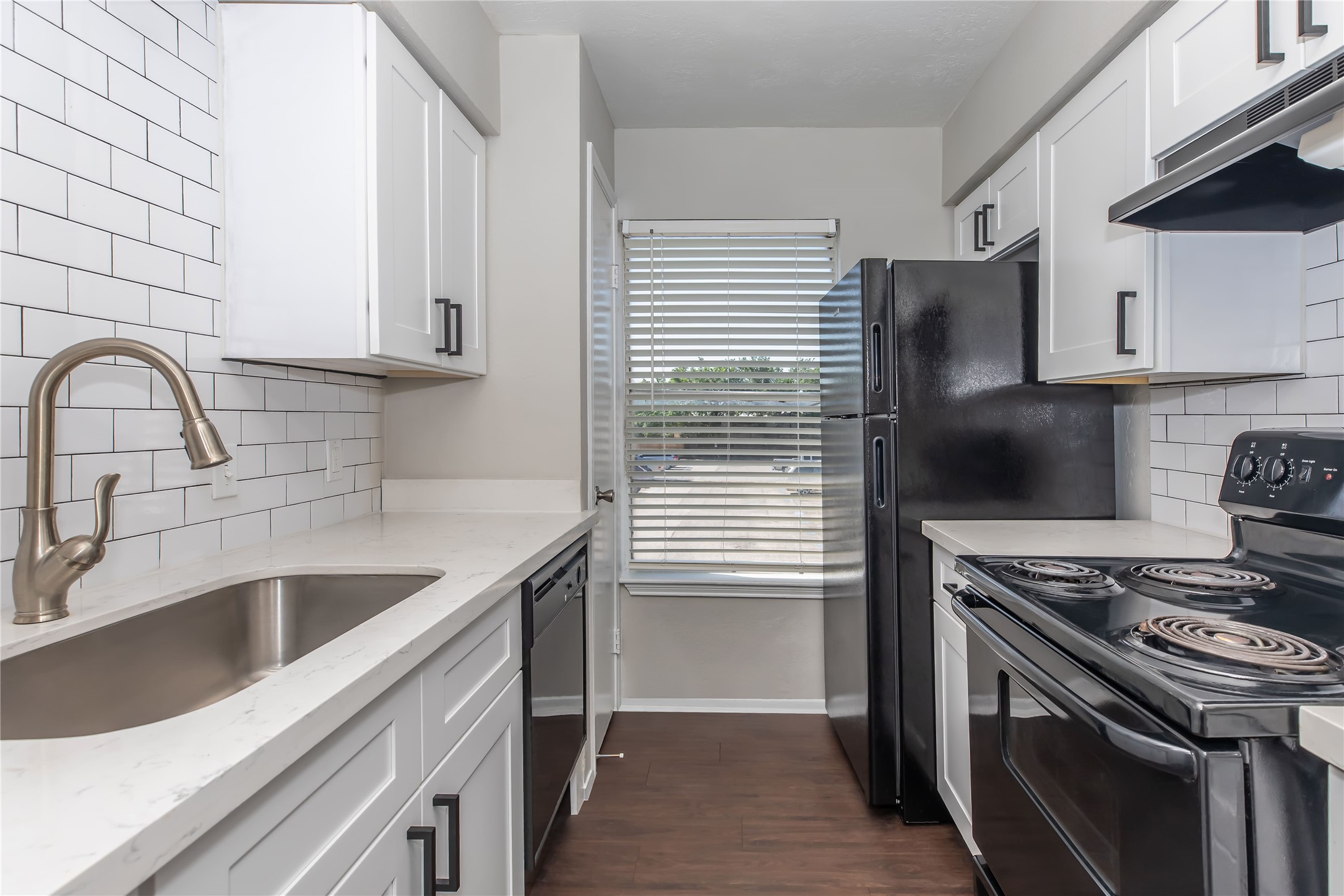 1515 Campbell Road, Unit 185 Houston, TX 77055 - Photo 1 of 6 a kitchen with stainless steel appliances granite countertop a sink stove and refrigerator