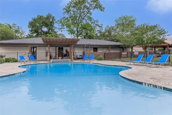a view of a swimming pool with outdoor seating
