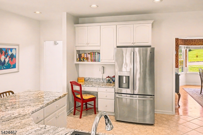 2 Moonlight Trail Flemington, NJ 08822 - Photo 14 of 50 a kitchen with stainless steel appliances granite countertop a refrigerator a stove a sink a dining table and chairs with wooden floor