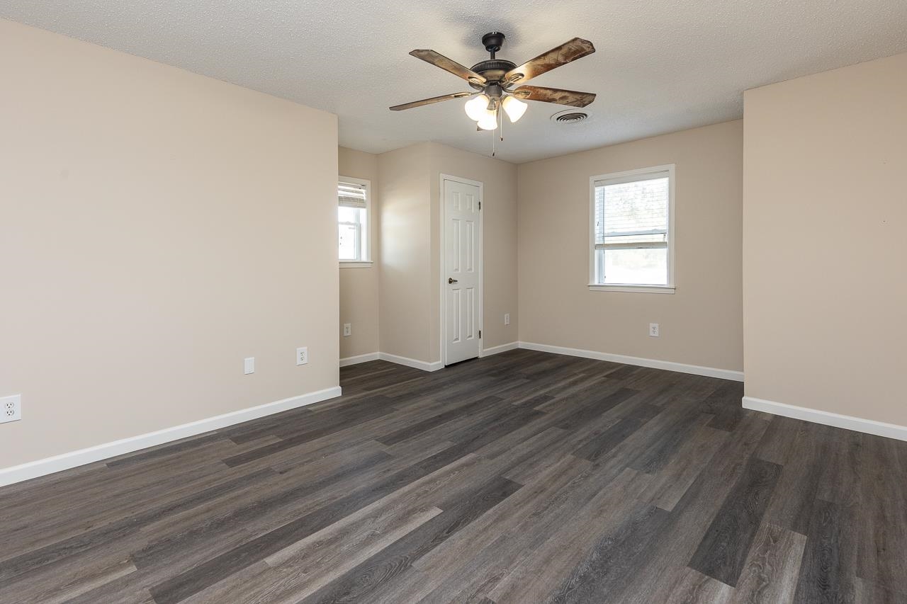 2718 Kate Bond Road Memphis, TN 38133 - Photo 29 of 39 Spare room with dark wood finished floors, plenty of natural light, a textured ceiling, and a ceiling fan