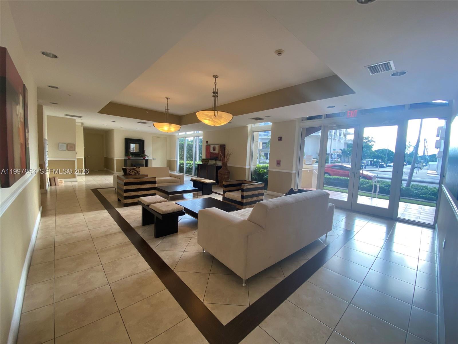 2425 Southwest 27th Avenue, Unit 1008 Miami, FL 33145 - Photo 1 of 20 a living room with furniture and a flat screen tv