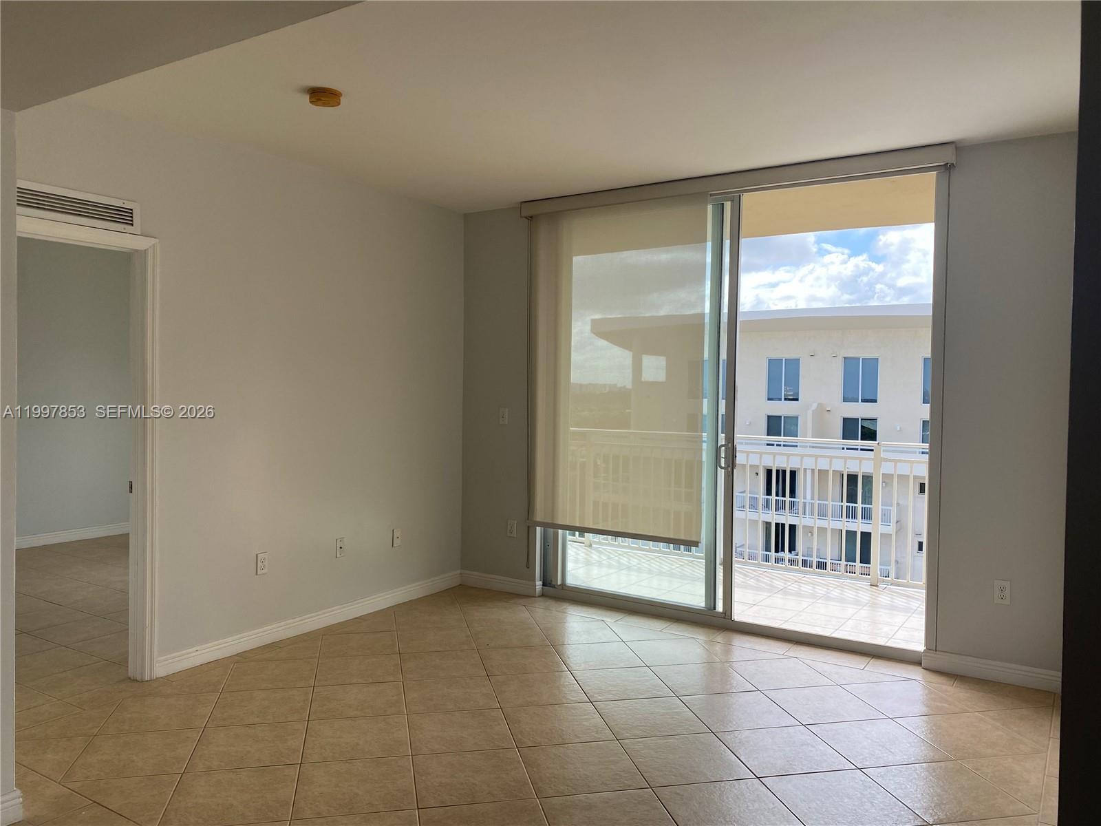 2425 Southwest 27th Avenue, Unit 1008 Miami, FL 33145 - Photo 12 of 20 a view of an empty room with a window