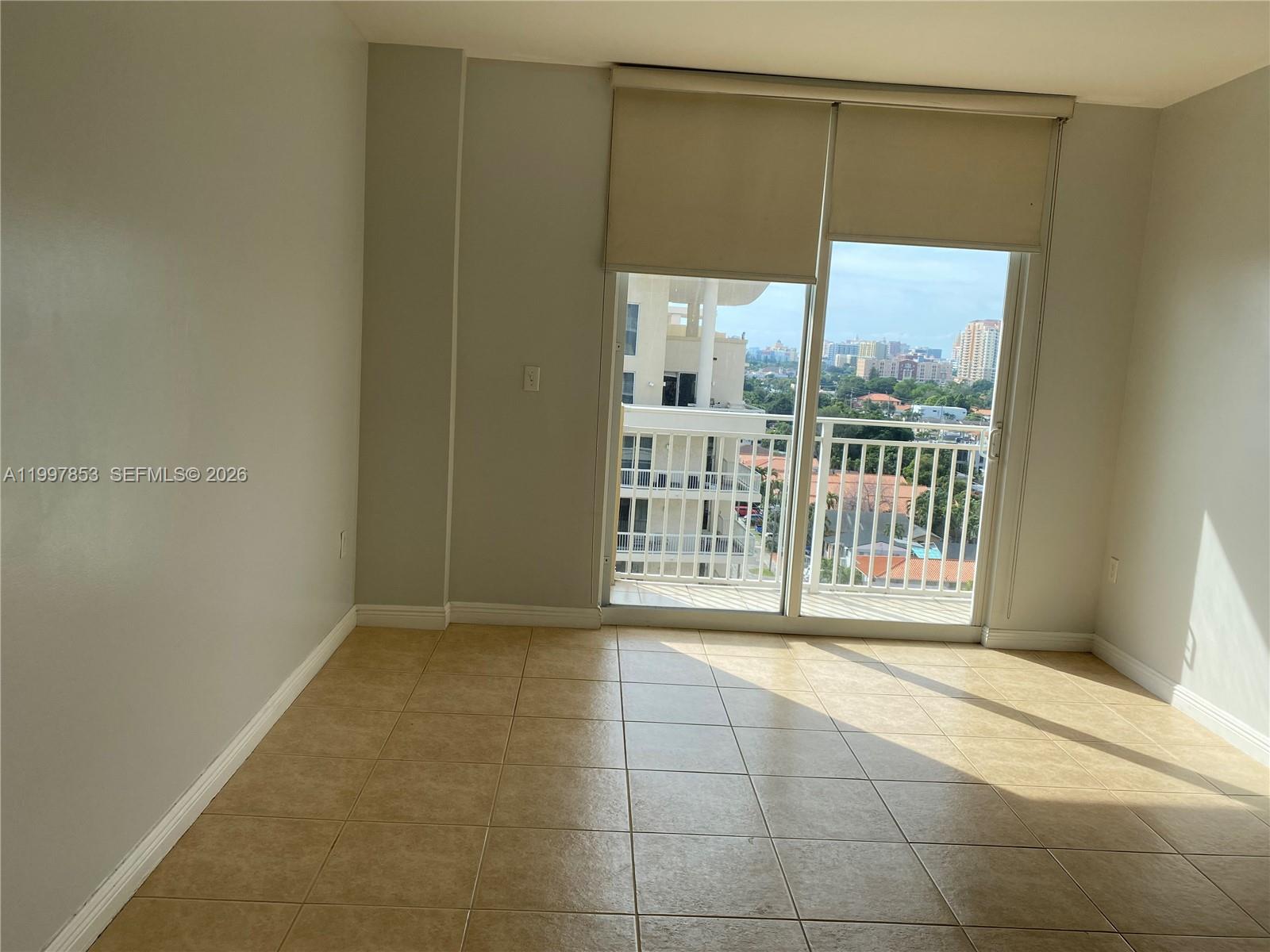 2425 Southwest 27th Avenue, Unit 1008 Miami, FL 33145 - Photo 6 of 20 a view of a glass door with a yard from a balcony