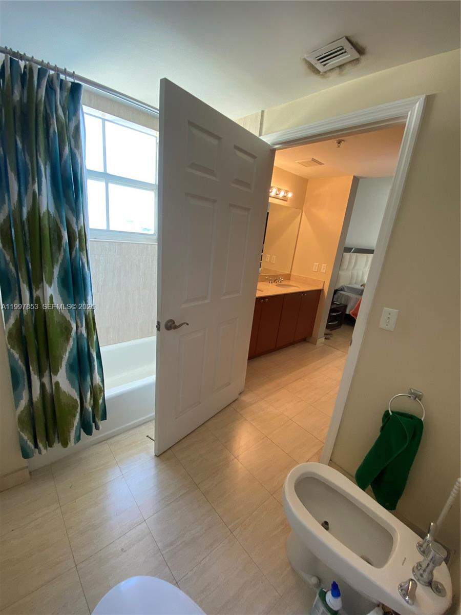 2425 Southwest 27th Avenue, Unit 1008 Miami, FL 33145 - Photo 10 of 20 a living room with furniture and a large window