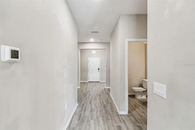 a view of a kitchen with stainless steel appliances granite countertop a stove a refrigerator a sink and a microwave