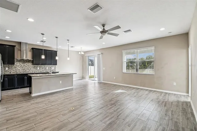 a kitchen with stainless steel appliances granite countertop plenty wooden cabinets counter space a sink and wooden floor