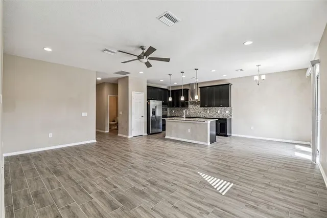 a kitchen with stainless steel appliances granite countertop a sink a stove microwave and refrigerator