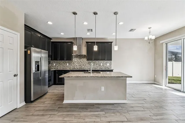 a view of a livingroom with a ceiling fan and wooden floor