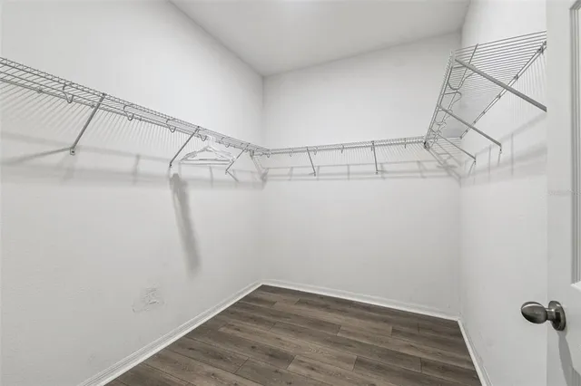 a bathroom with a granite countertop sink a toilet a mirror and shower