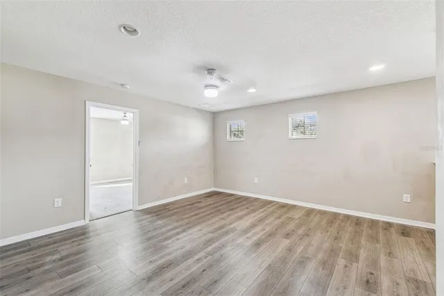 a view of a house with a backyard and a tree