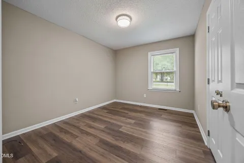 a bedroom with bed and a night stand