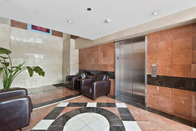 a lobby with furniture and rug