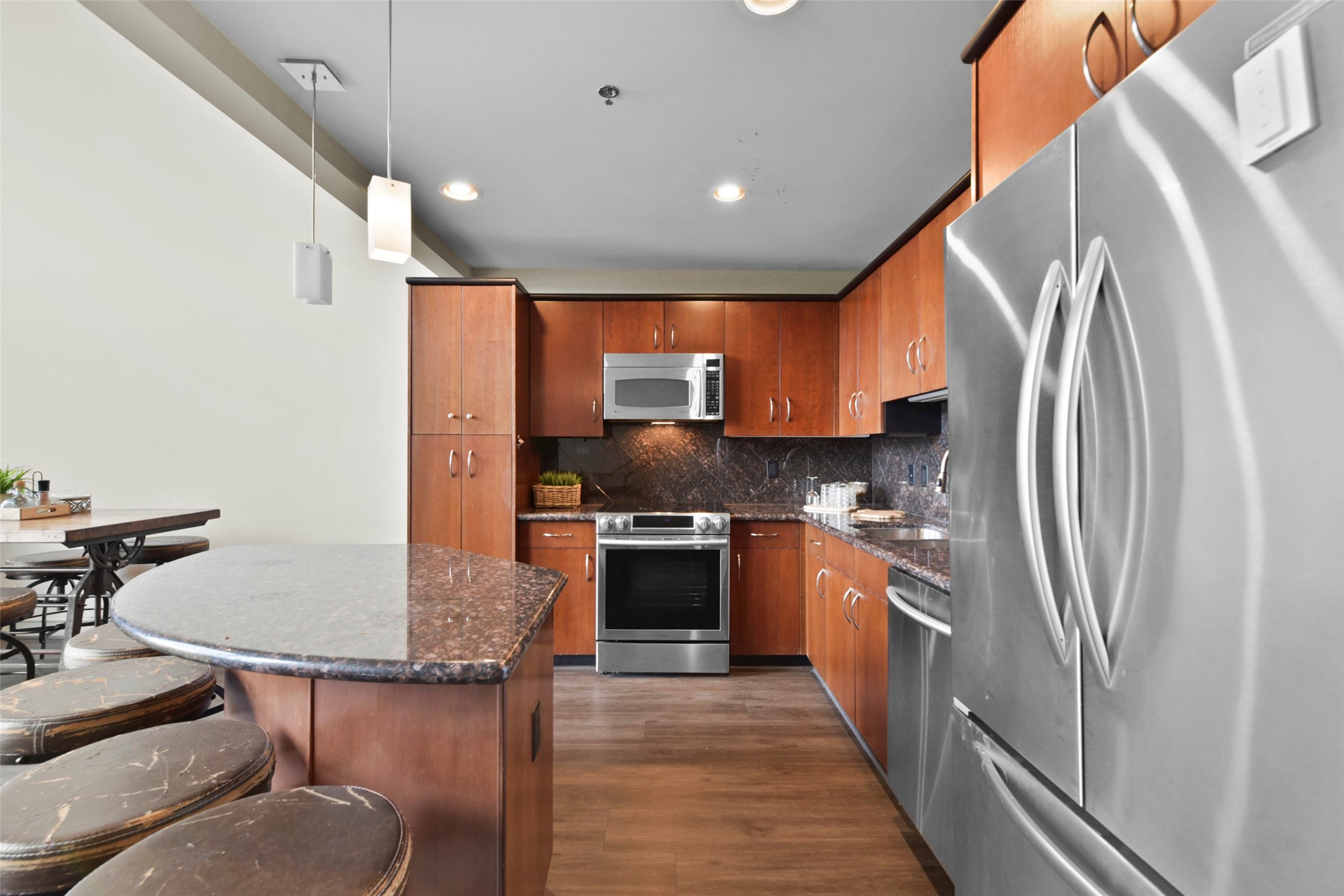 3311 Yupon Street, Unit 611 Houston, TX 77006 - Photo 5 of 17 a kitchen with stainless steel appliances granite countertop a refrigerator and a stove top oven