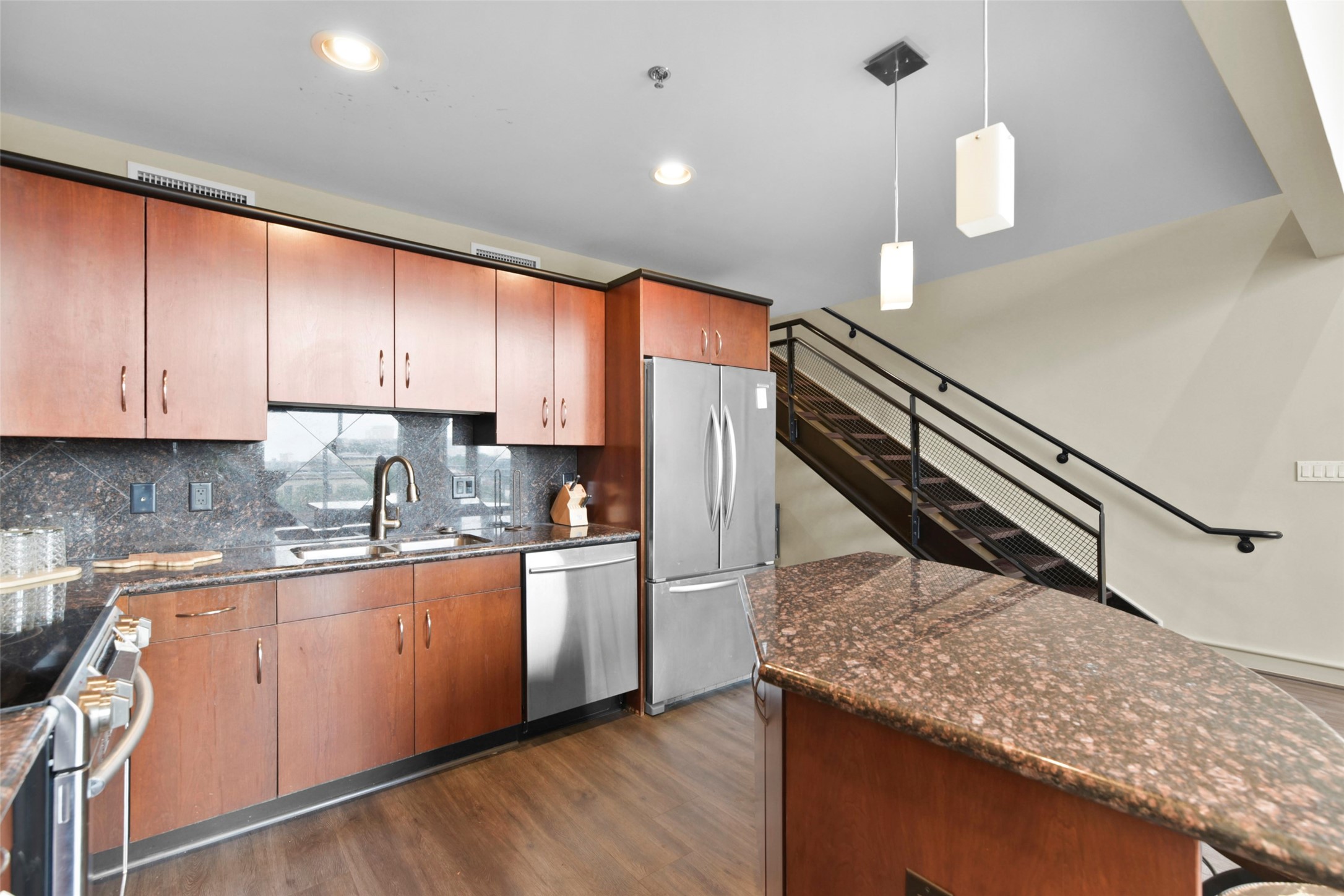3311 Yupon Street, Unit 611 Houston, TX 77006 - Photo 6 of 17 a kitchen with stainless steel appliances granite countertop a sink a stove and a refrigerator