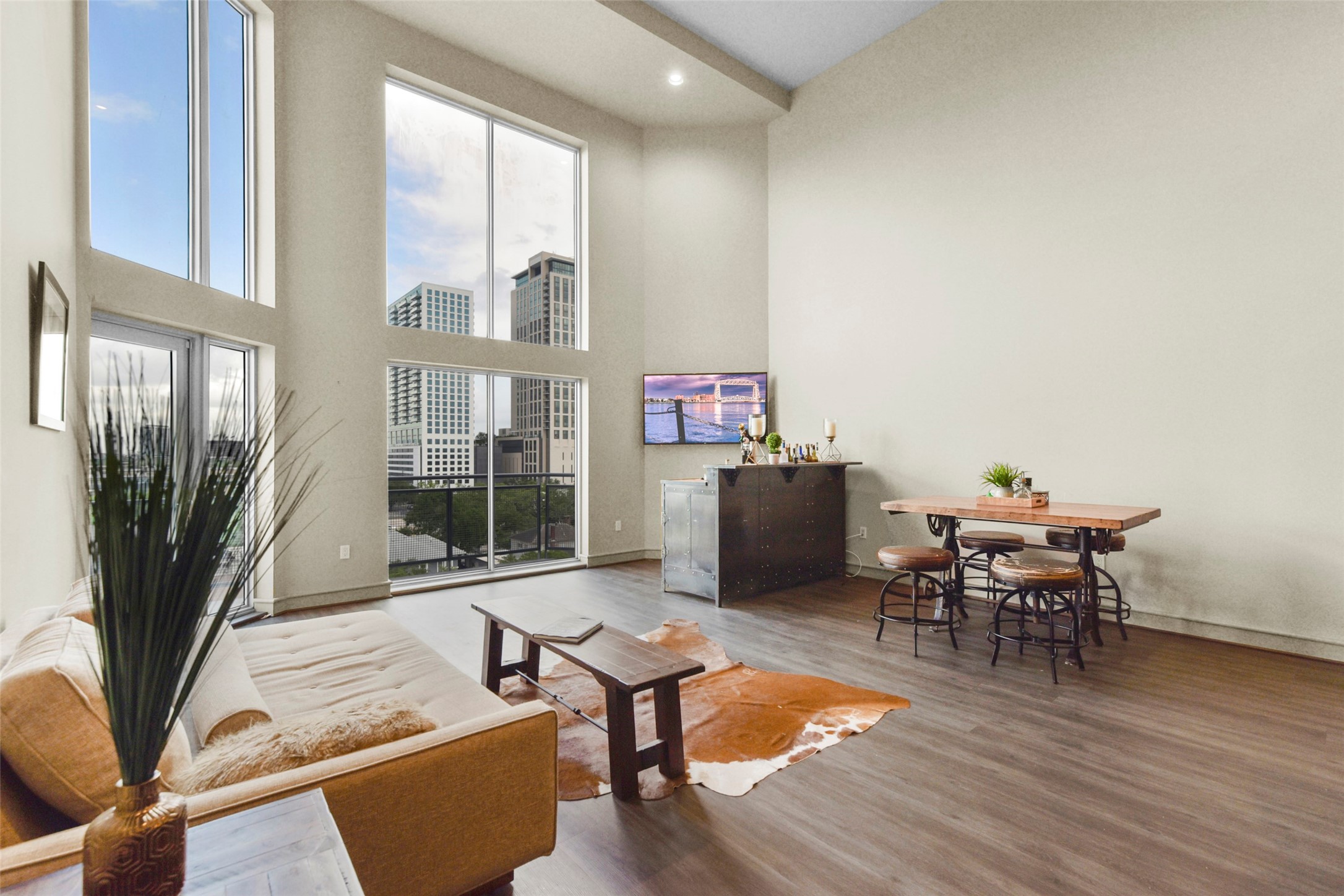 3311 Yupon Street, Unit 611 Houston, TX 77006 - Photo 8 of 17 a living room with furniture a table and a floor to ceiling window