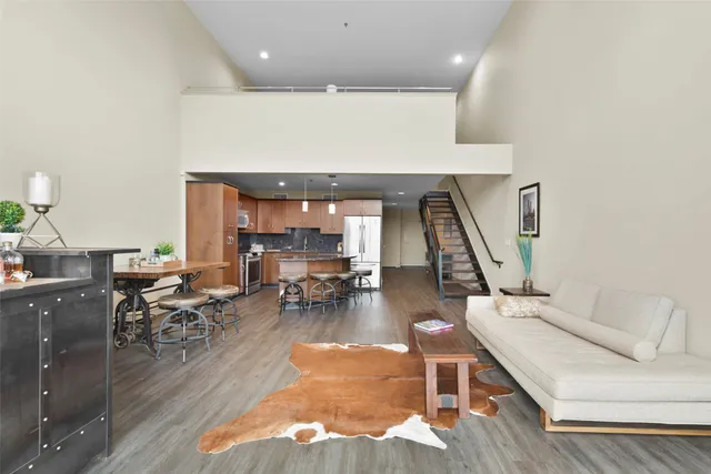 a living room with furniture and a wooden floor