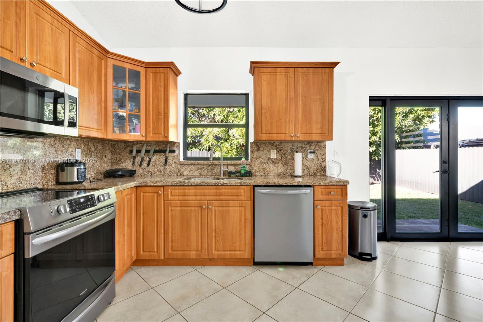 12221 Southwest 93rd Street Miami, FL 33186 - Photo 12 of 41 a kitchen with stainless steel appliances granite countertop a stove a sink and a microwave