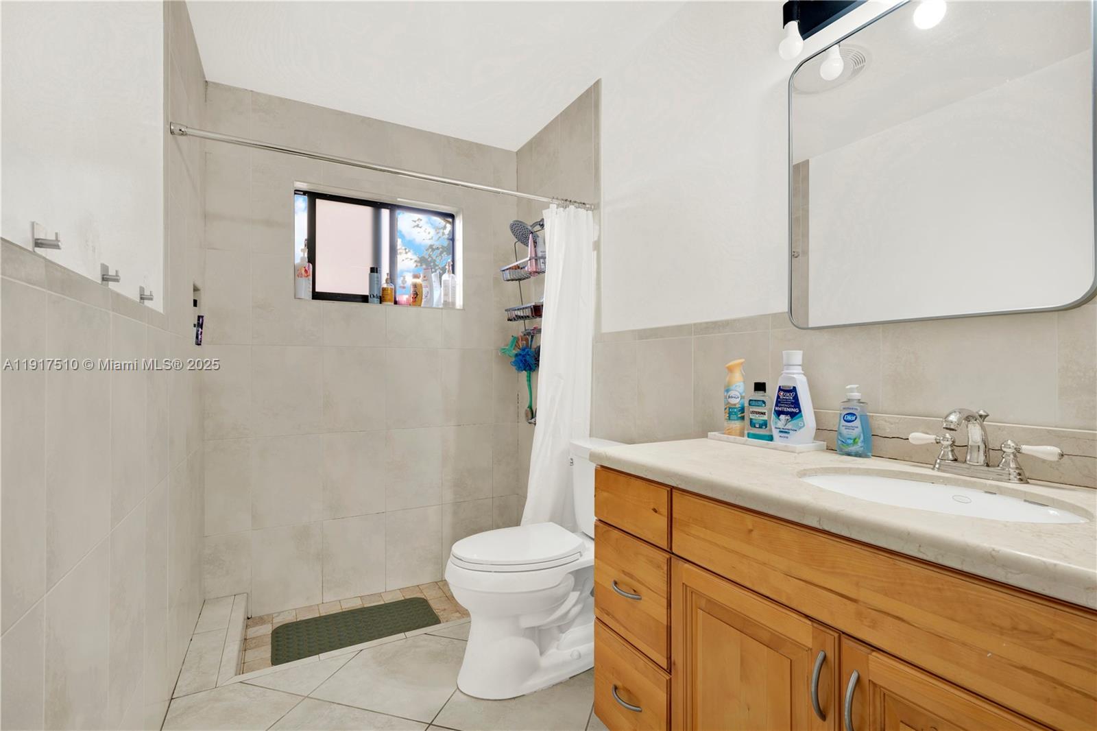 12221 Southwest 93rd Street Miami, FL 33186 - Photo 17 of 41 a bathroom with a sink a toilet and a mirror