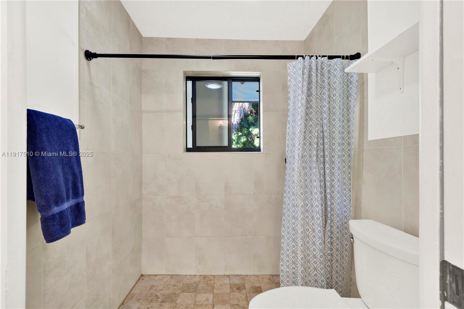 12221 Southwest 93rd Street Miami, FL 33186 - Photo 18 of 41 a bathroom with a toilet and a shower