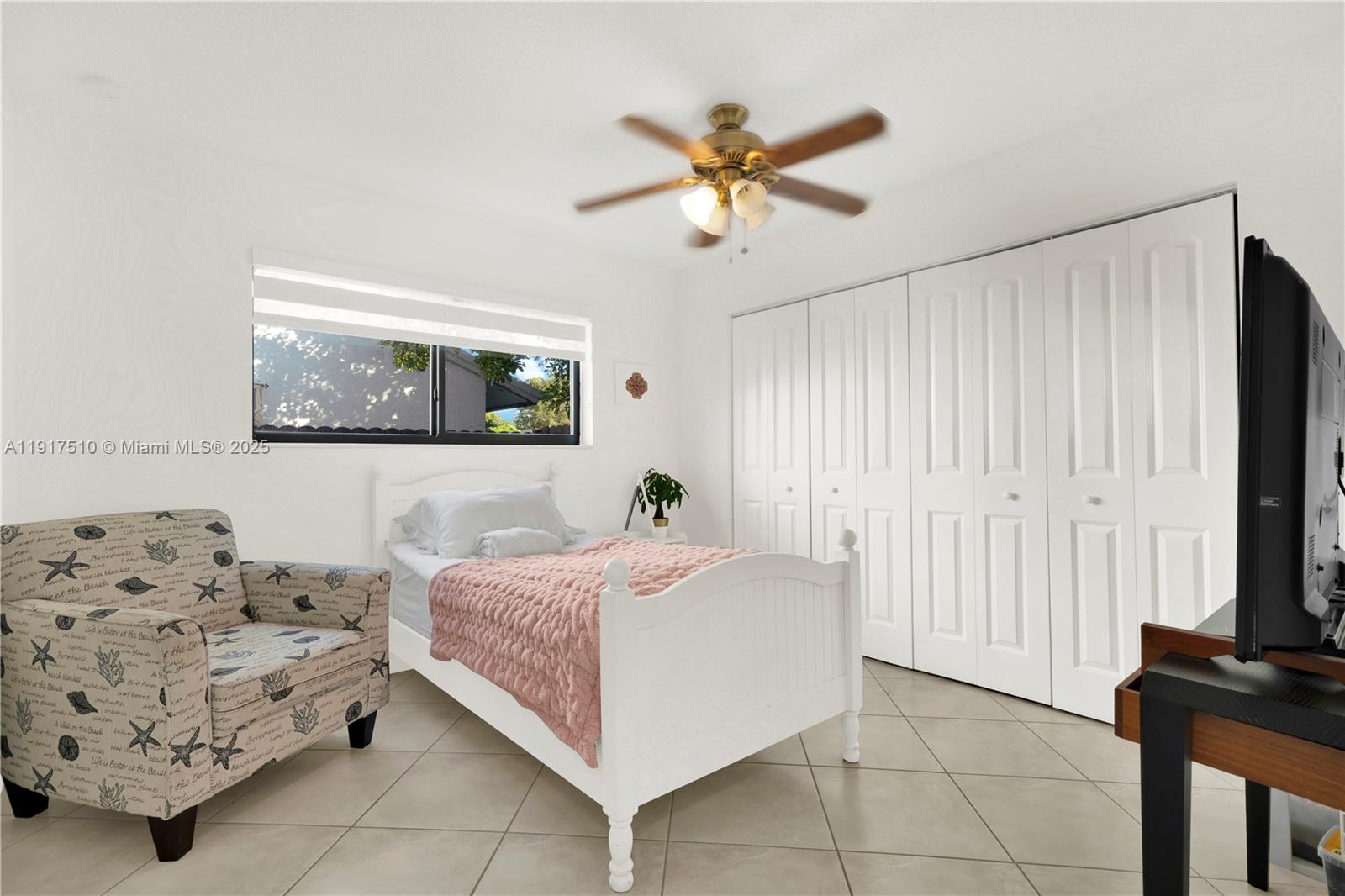 12221 Southwest 93rd Street Miami, FL 33186 - Photo 29 of 42 a bedroom with a bed and a window