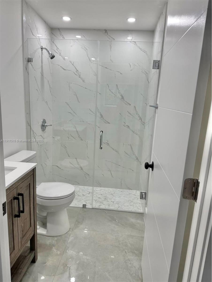 12221 Southwest 93rd Street Miami, FL 33186 - Photo 34 of 42 a bathroom with a toilet sink and shower