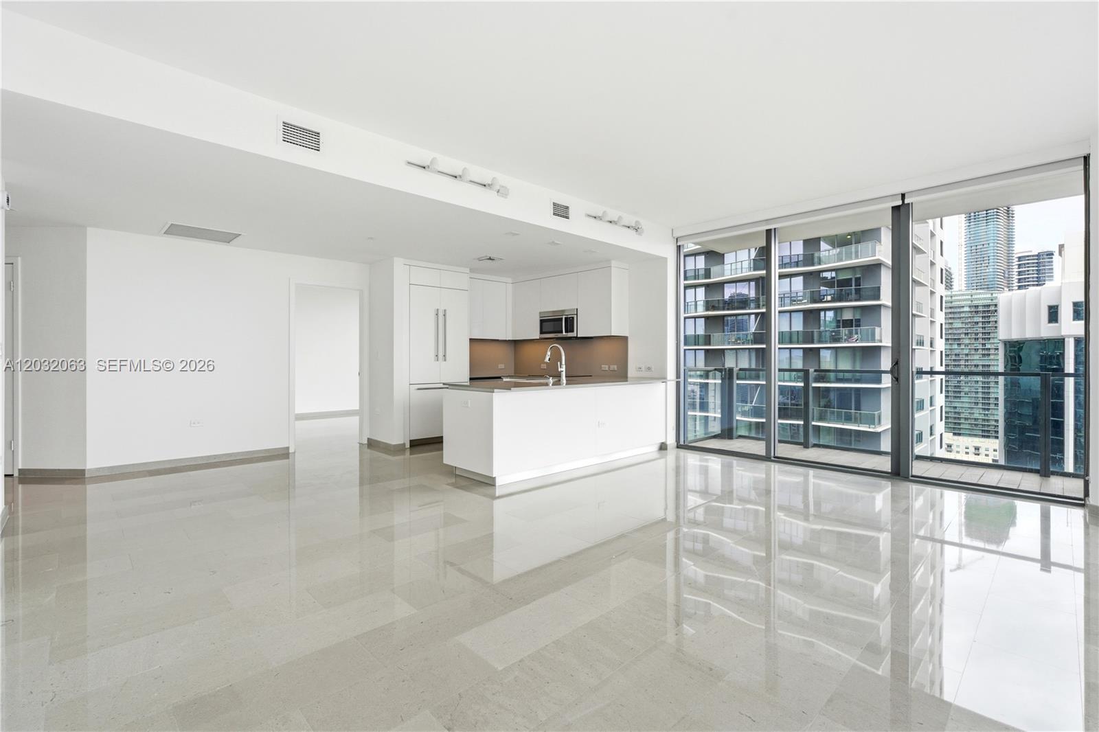 88 Southwest 7th Street, Unit 2302 Miami, FL 33130 - Photo 3 of 26 a view of kitchen with furniture and refrigerator