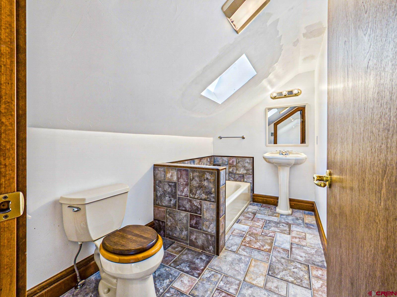 16331 2550th Road Cedaredge, CO 81413 - Photo 33 of 45 a bathroom with a toilet and a shower