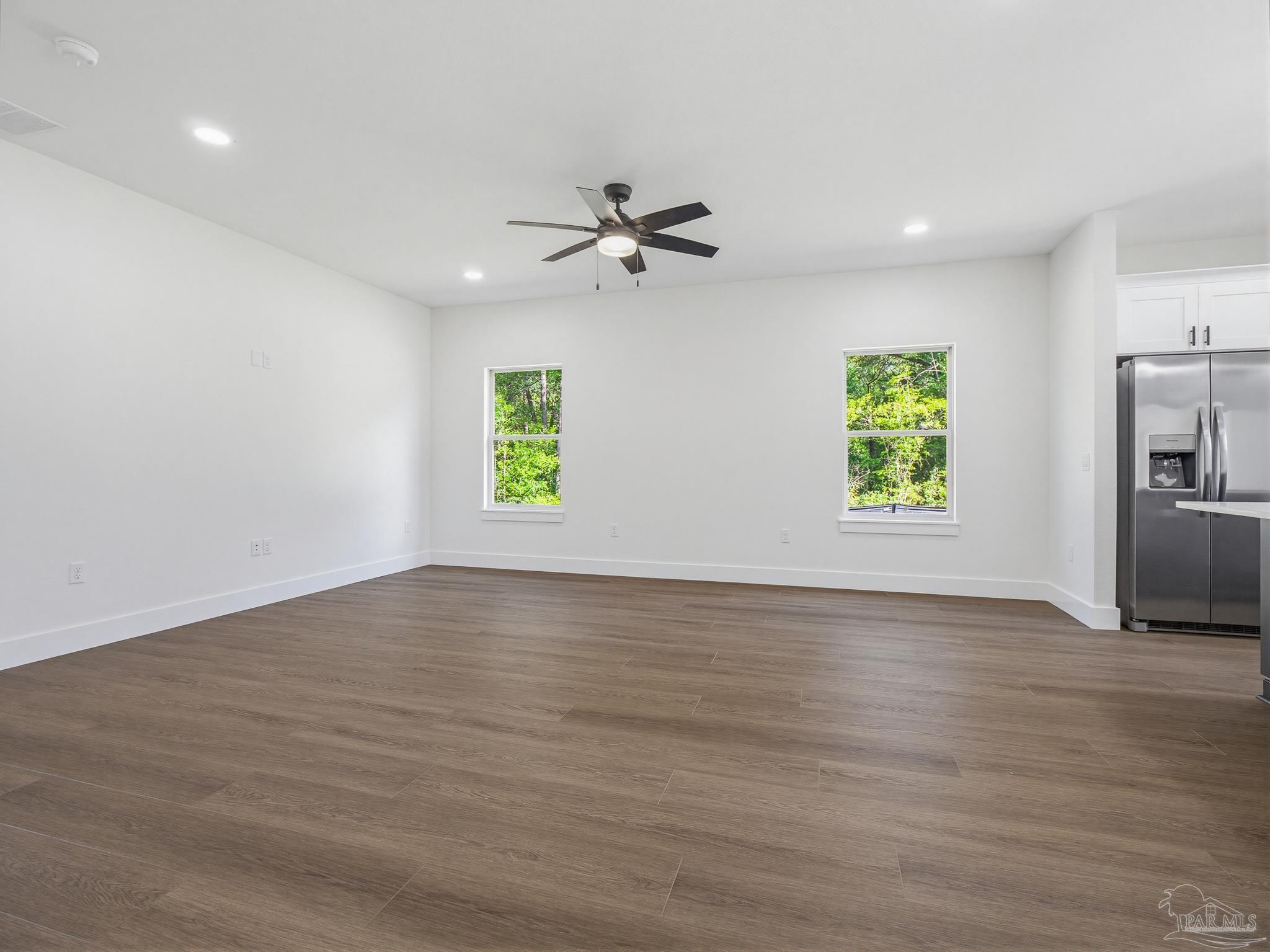 5724 Riviera Drive Milton, FL 32583 - Photo 10 of 52 an empty room with windows and a ceiling fan