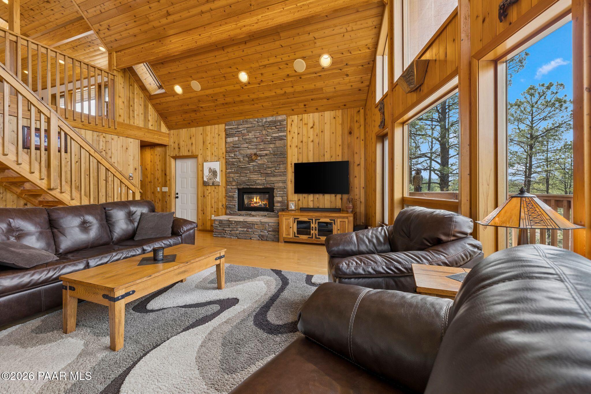 35 East Colonels Way Prescott, AZ 86303 - Photo 11 of 70 a living room with furniture a flat screen tv and a floor to ceiling window