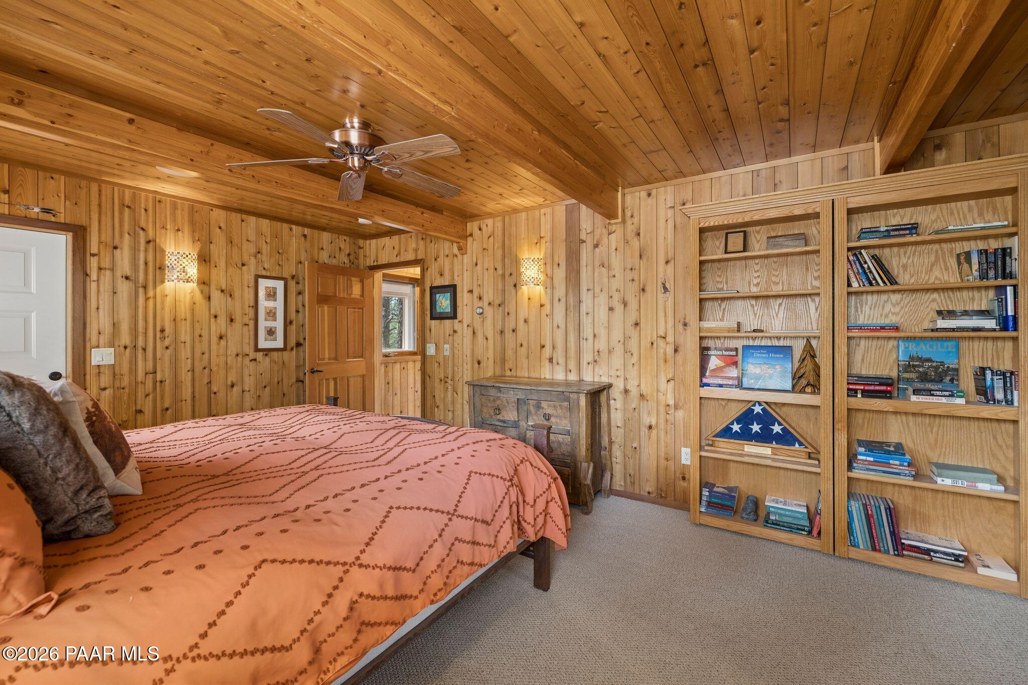 35 East Colonels Way Prescott, AZ 86303 - Photo 27 of 70 a bedroom with a bed a book shelf and a shower