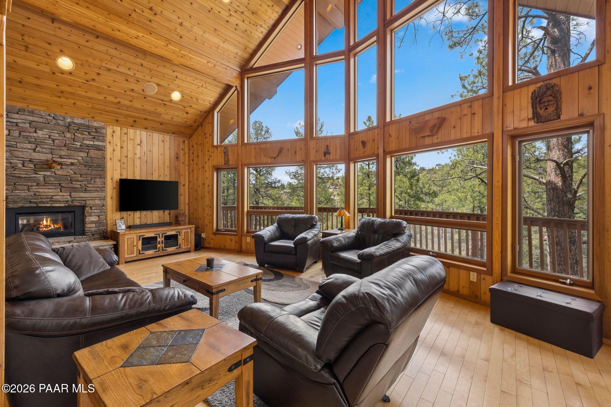 35 East Colonels Way Prescott, AZ 86303 - Photo 7 of 70 a living room with furniture a flat screen tv and a floor to ceiling window