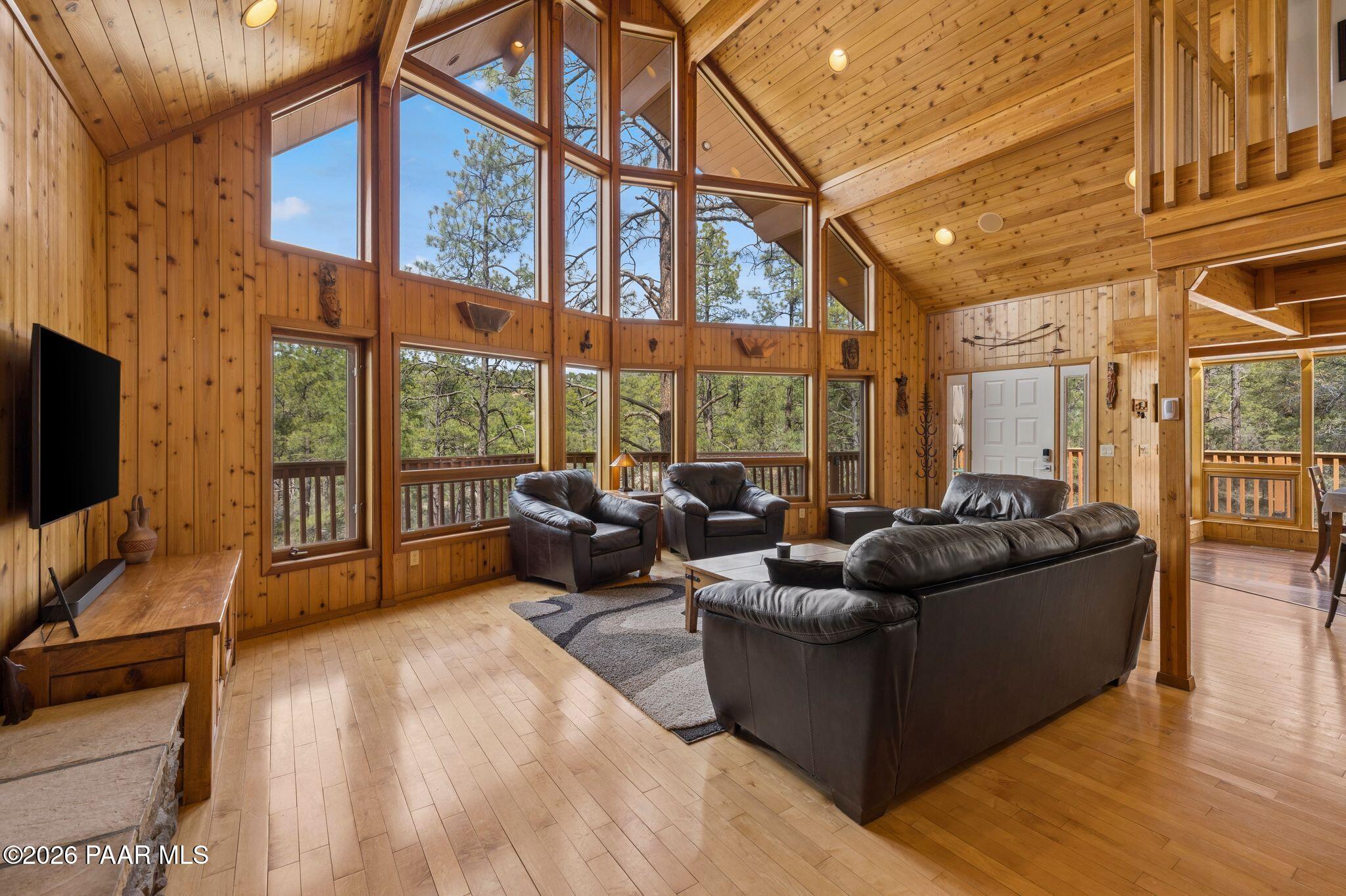 35 East Colonels Way Prescott, AZ 86303 - Photo 9 of 70 a living room with furniture tv and a floor to ceiling window