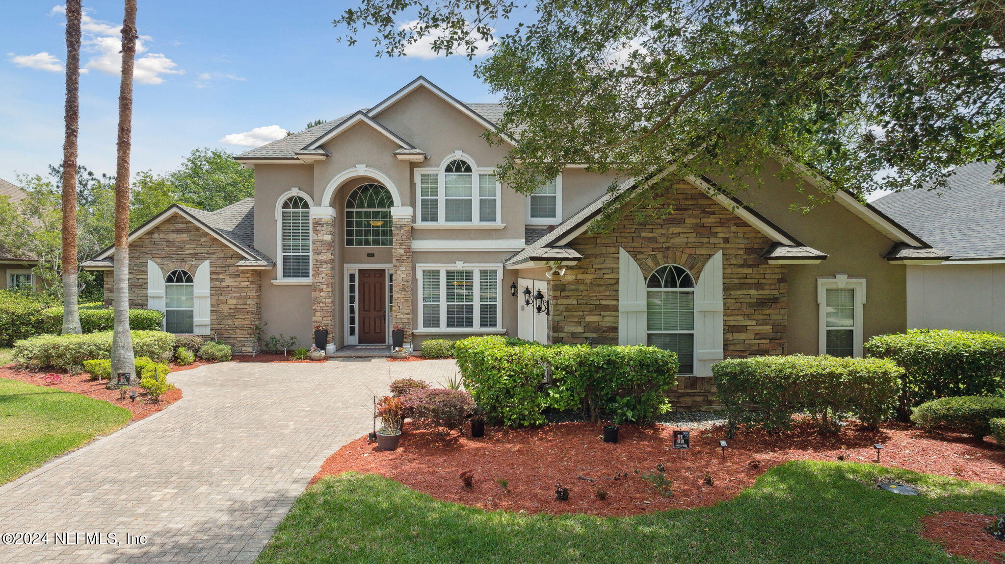 a front view of a house with a garden