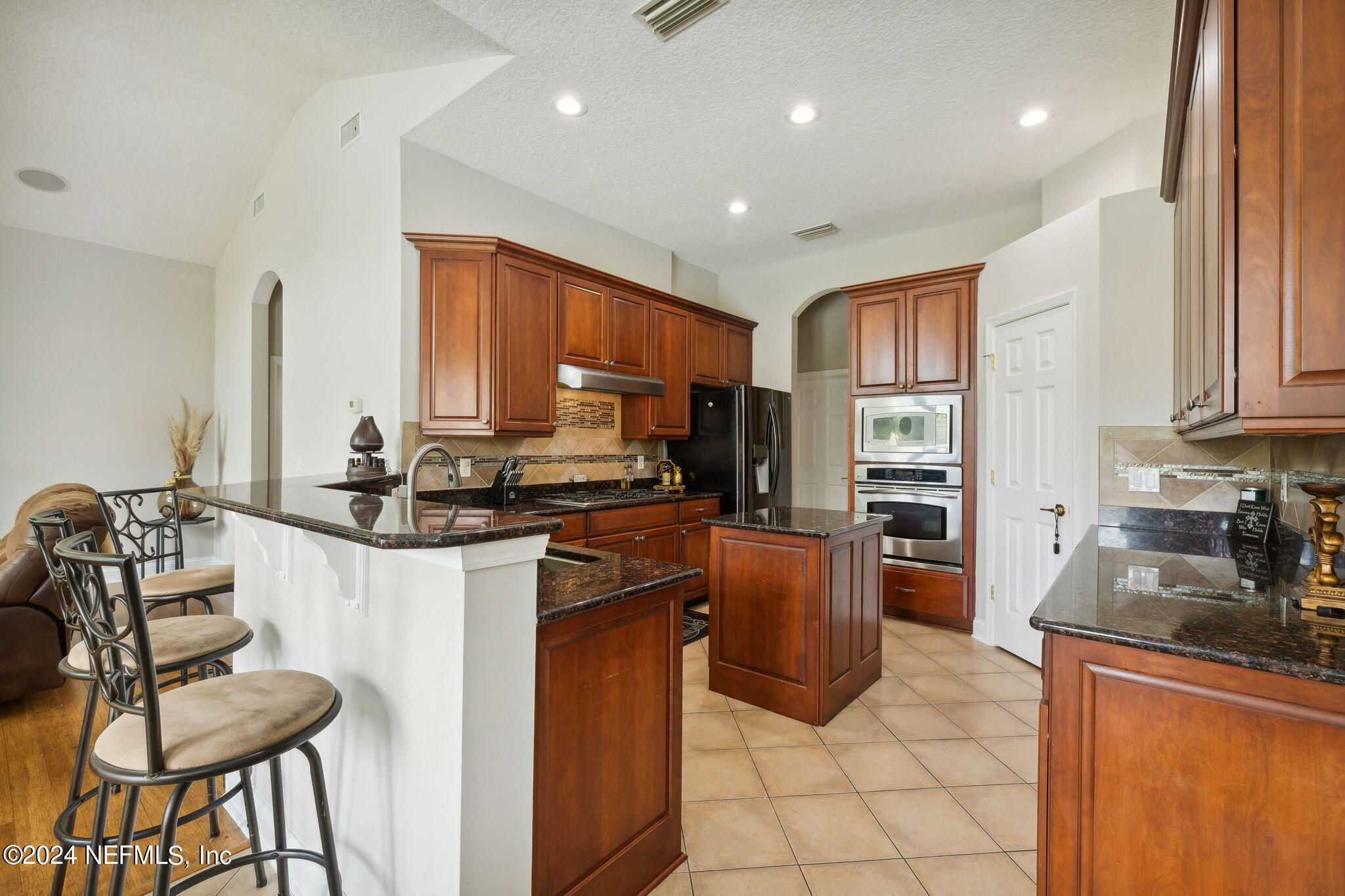 1403 Eagle Crossing Drive Orange Park, FL 32065 - Photo 11 of 71 a kitchen with stainless steel appliances granite countertop a stove top oven a sink dishwasher and a refrigerator