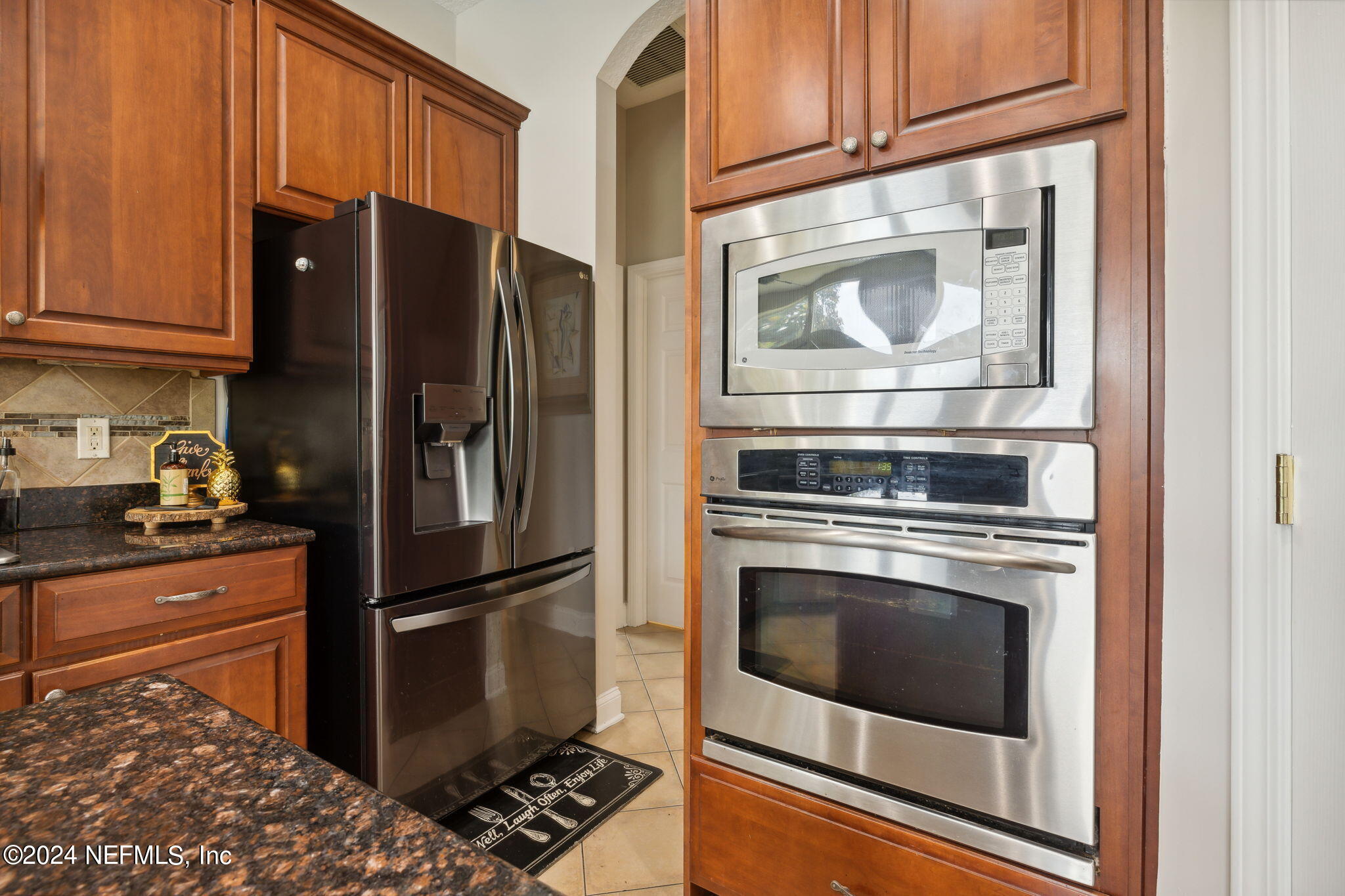 1403 Eagle Crossing Drive Orange Park, FL 32065 - Photo 12 of 71 a kitchen with granite countertop stainless steel appliances and wooden cabinets