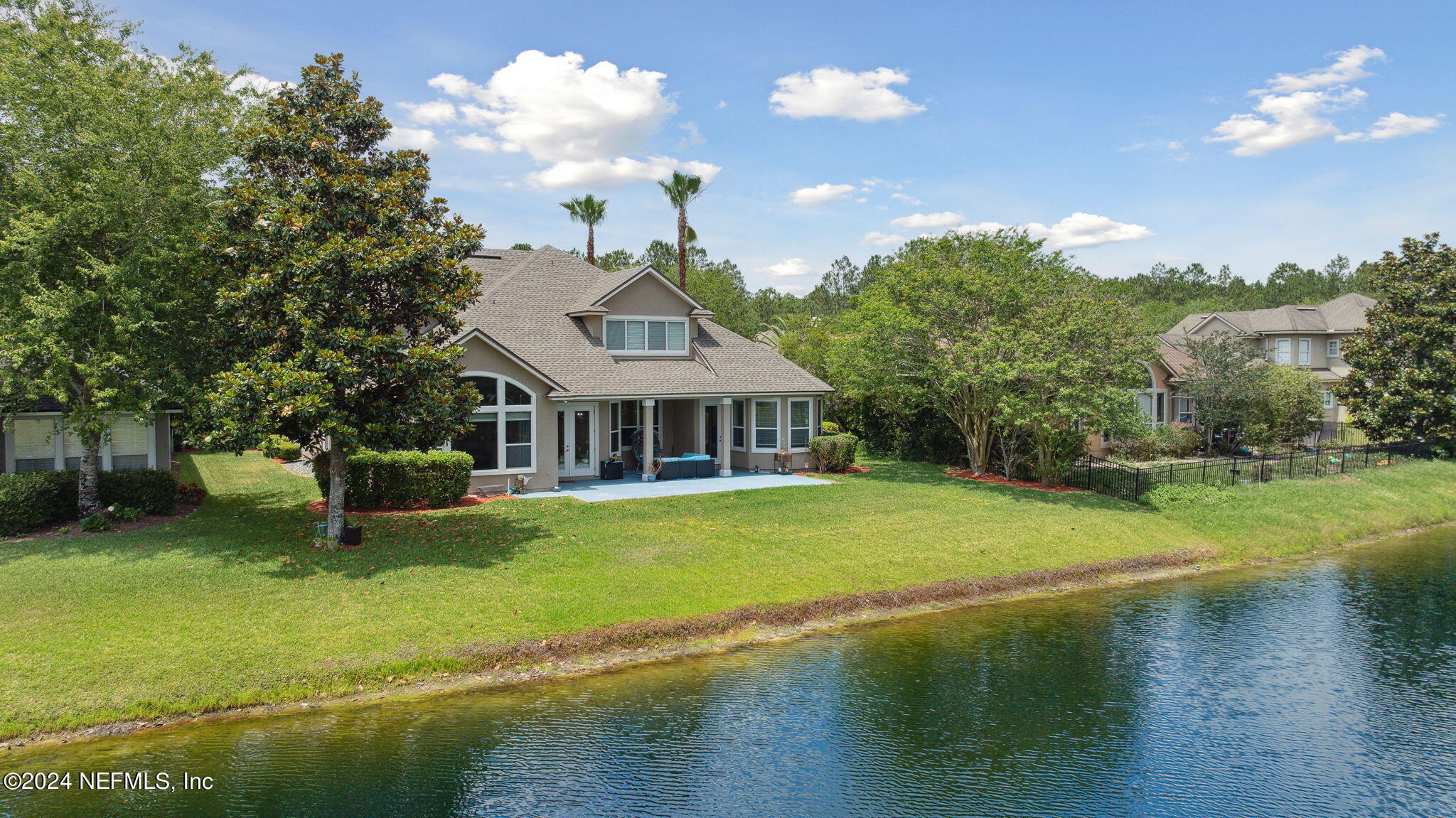 1403 Eagle Crossing Drive Orange Park, FL 32065 - Photo 35 of 71 a front view of a house with a garden and lake view